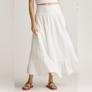 Elegant white maxi skirt by Quince. Flowy design with a ruffled hem. Size large.